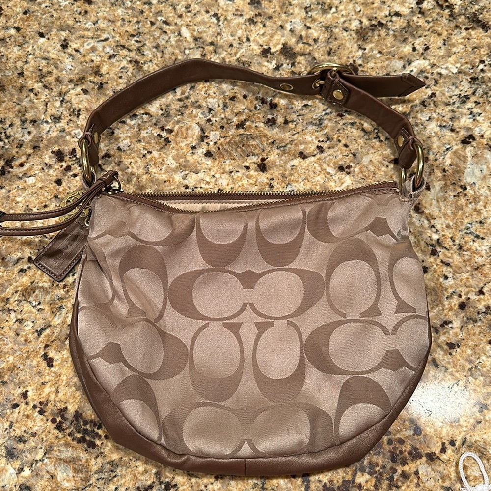 Coach signature bronze satin like hobo purse in good condition.